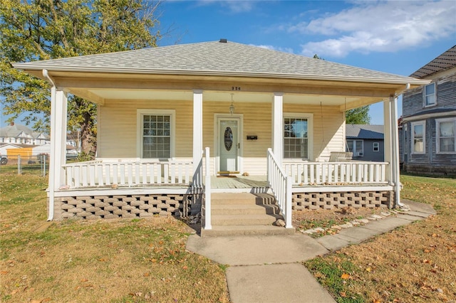 bungalow-style house with covered porch and a front yard