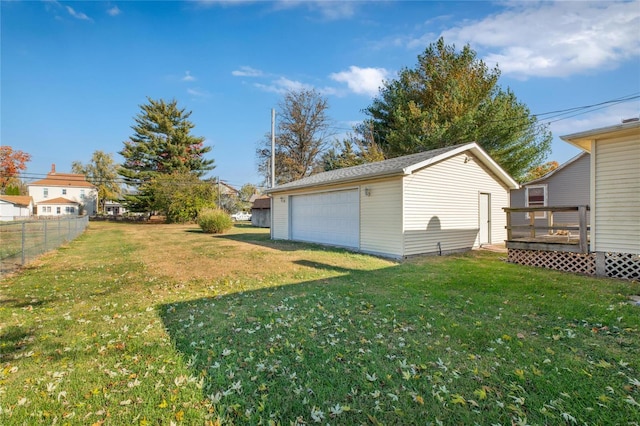 view of yard featuring a deck, an outbuilding, and a garage