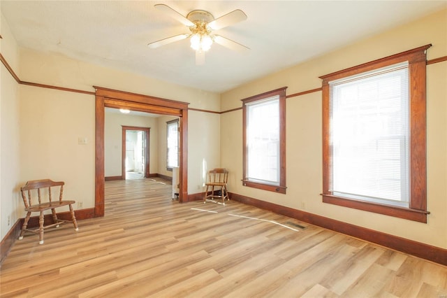 spare room featuring light hardwood / wood-style flooring and ceiling fan