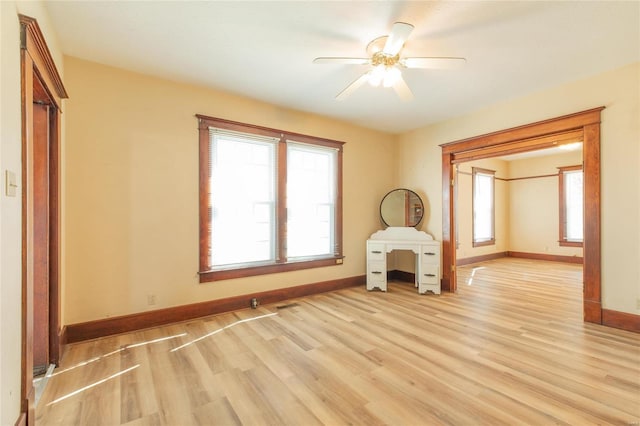 unfurnished room with light wood-type flooring and ceiling fan