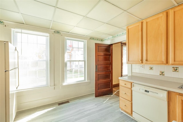 kitchen featuring white appliances, a paneled ceiling, decorative backsplash, and light hardwood / wood-style flooring