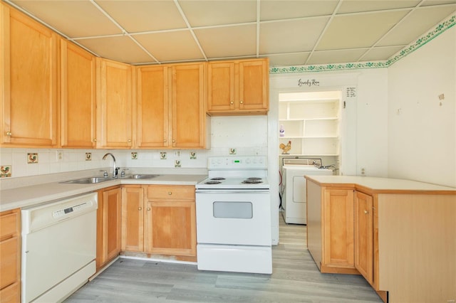 kitchen featuring light hardwood / wood-style floors, washer / clothes dryer, sink, and white appliances