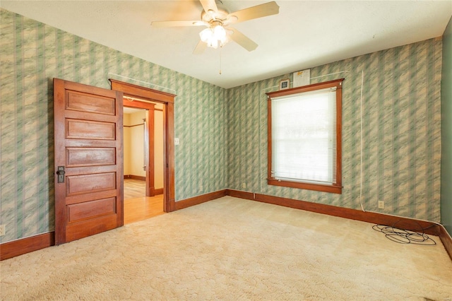 spare room with ceiling fan and carpet flooring