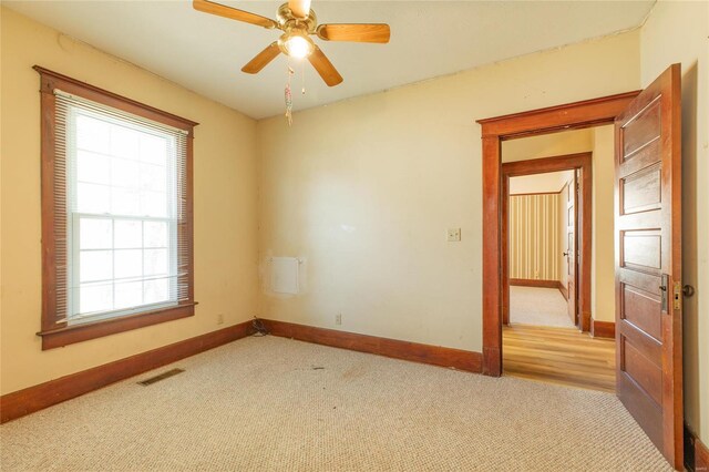 carpeted empty room featuring ceiling fan