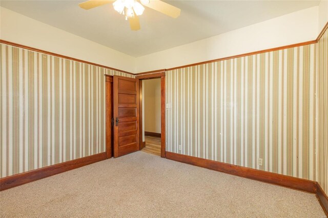 unfurnished bedroom with ceiling fan and carpet floors