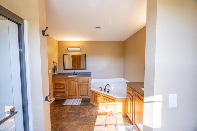 bathroom featuring vanity and a tub to relax in