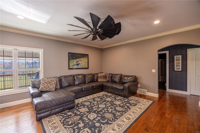 living room featuring ceiling fan, ornamental molding, and hardwood / wood-style floors