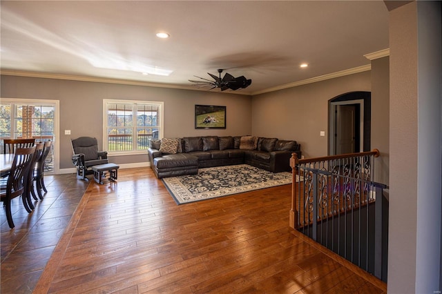 living room with ceiling fan, hardwood / wood-style flooring, and ornamental molding