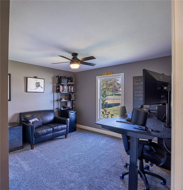 office area featuring a textured ceiling, carpet, and ceiling fan