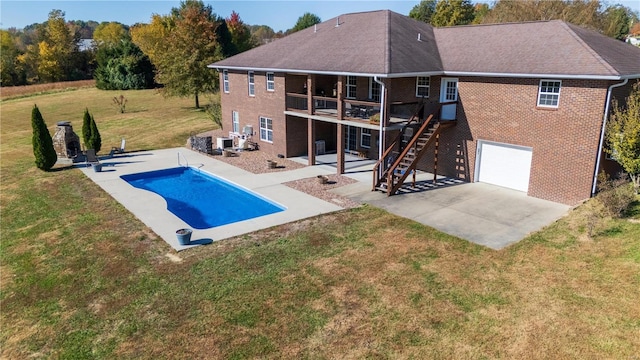 rear view of house featuring a patio, a swimming pool side deck, and a lawn