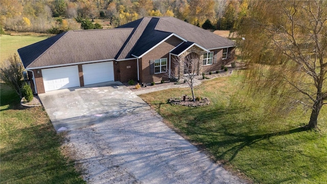 ranch-style home featuring a front lawn and a garage