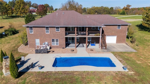 back of house featuring a patio area and a lawn