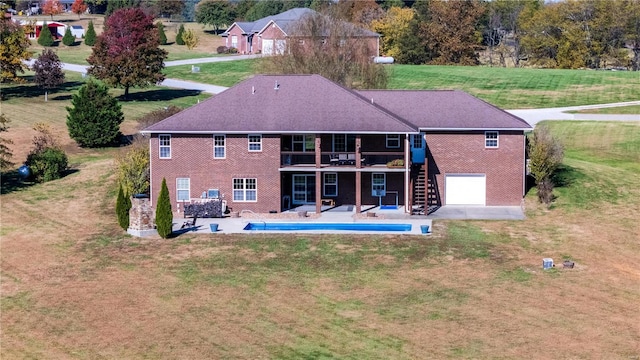 back of house with a patio and a lawn