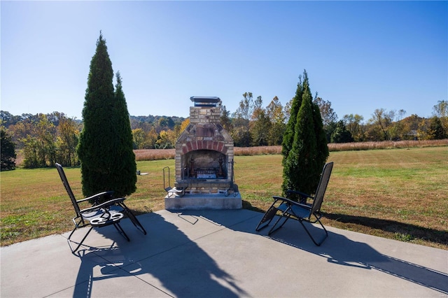 view of patio / terrace with an outdoor fireplace