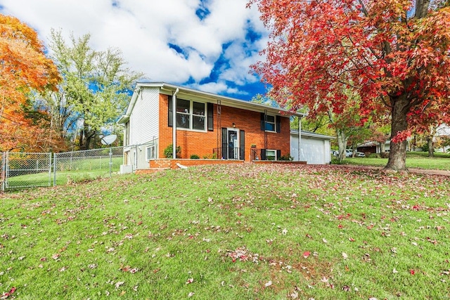 back of property with a garage and a lawn