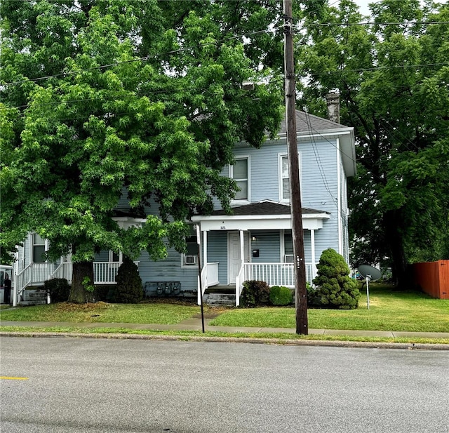 view of front of house featuring a porch and a front lawn