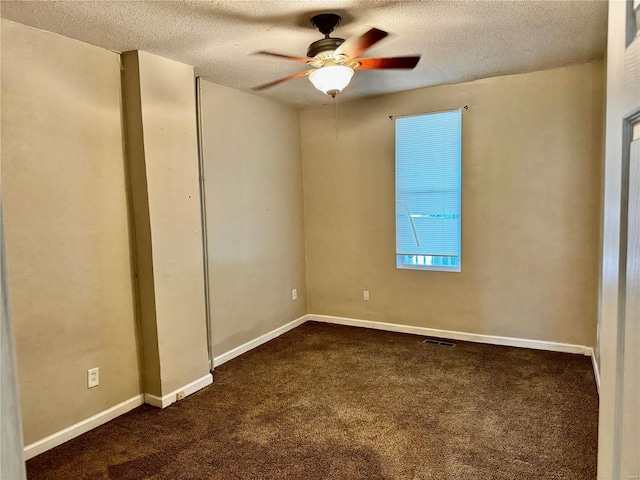 carpeted empty room featuring ceiling fan and a textured ceiling