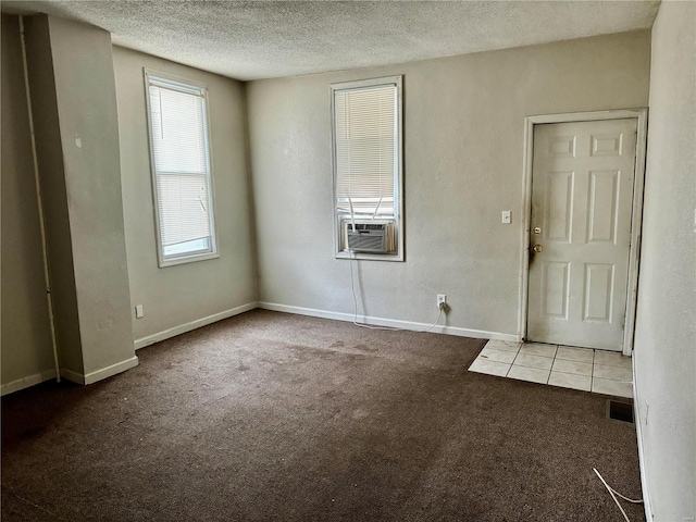 carpeted entrance foyer with cooling unit and a textured ceiling