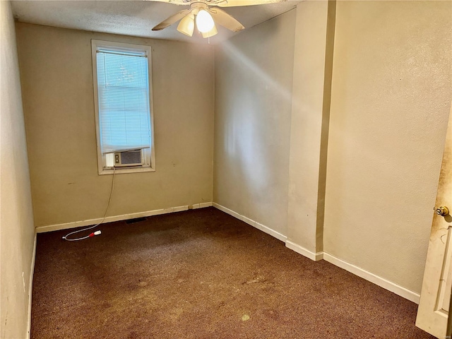 spare room with cooling unit, a textured ceiling, carpet flooring, and ceiling fan