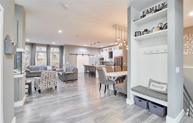 interior space with a barn door and light hardwood / wood-style flooring