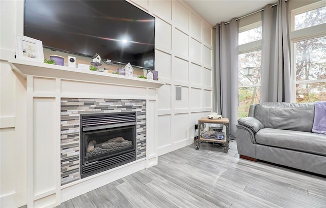 living room with a fireplace and light hardwood / wood-style flooring