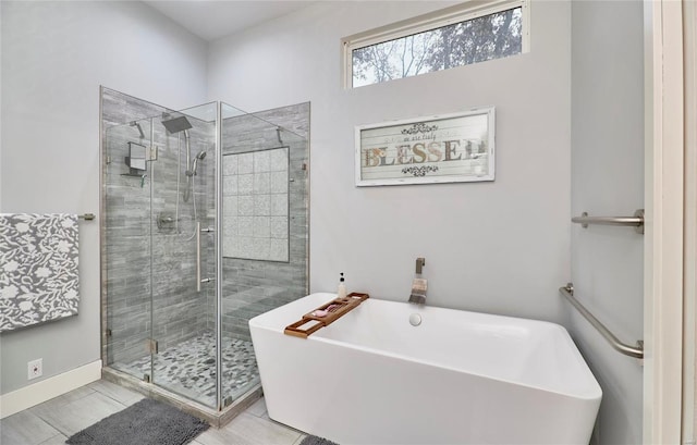 bathroom with shower with separate bathtub and tile patterned floors