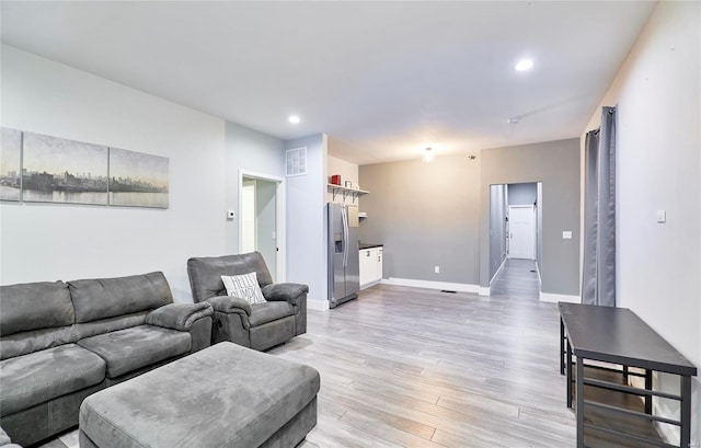 living room with light hardwood / wood-style flooring