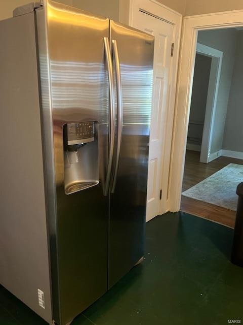 kitchen featuring dark hardwood / wood-style flooring and stainless steel fridge