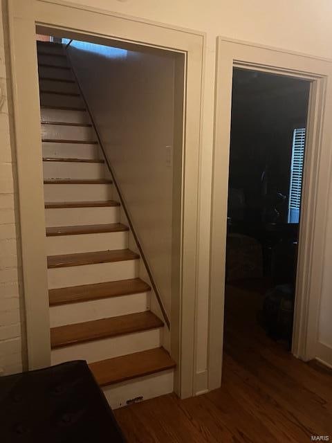 stairs featuring hardwood / wood-style floors