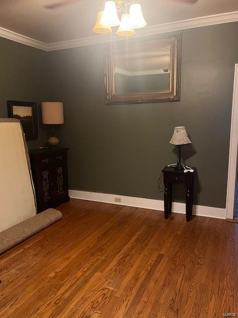 unfurnished bedroom with crown molding and hardwood / wood-style flooring