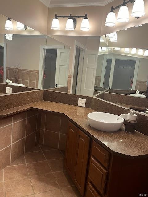 bathroom featuring vanity, tile patterned floors, and ornamental molding