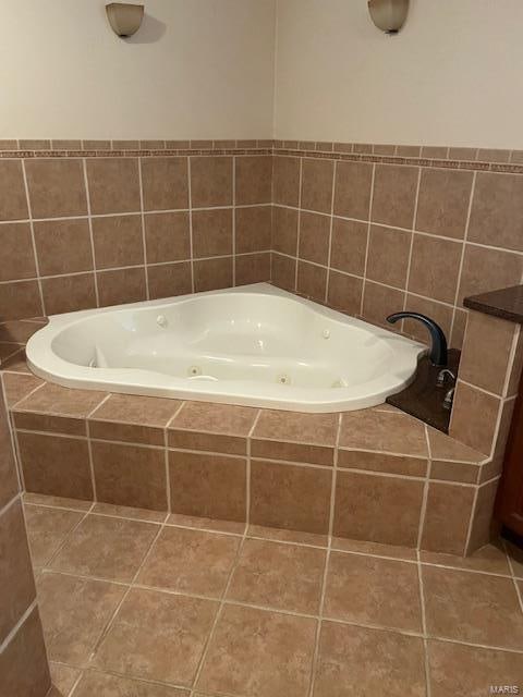 bathroom featuring tile patterned floors and tiled tub