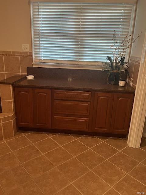 bathroom with tile walls and tile patterned flooring