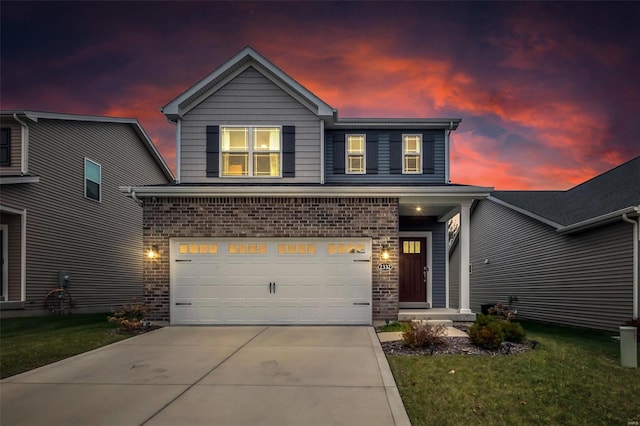 view of front of house featuring a garage and a lawn