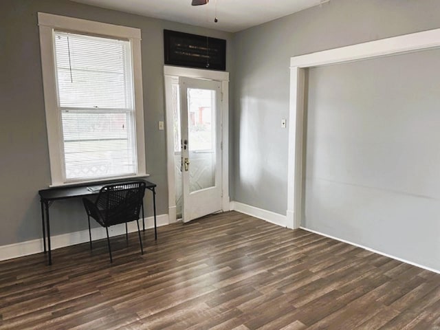 foyer entrance with dark hardwood / wood-style flooring and ceiling fan