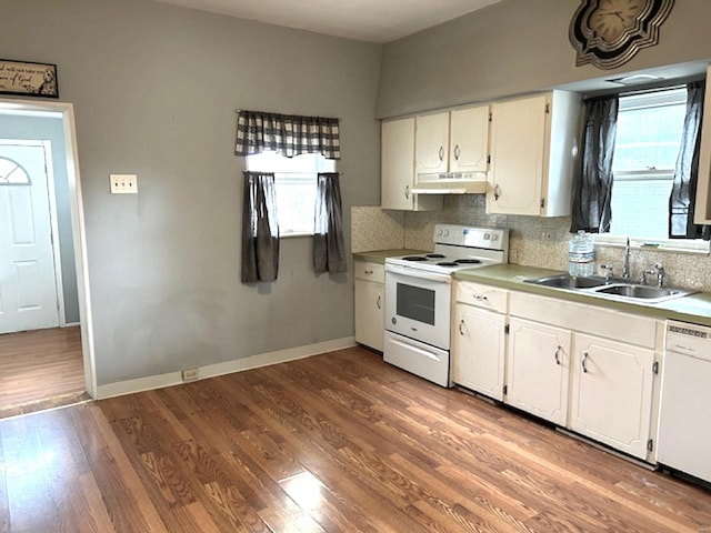 kitchen featuring sink, white cabinets, white appliances, light hardwood / wood-style floors, and backsplash