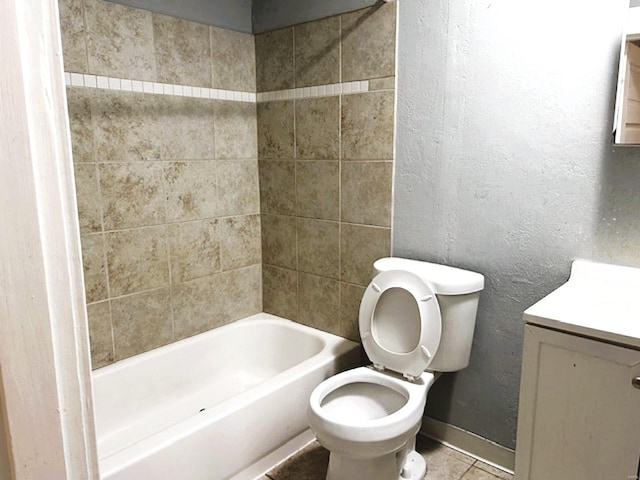 full bathroom with tile patterned floors, vanity, toilet, and tiled shower / bath combo