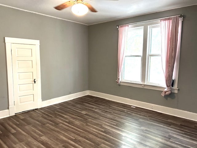 unfurnished room with dark hardwood / wood-style floors and ceiling fan