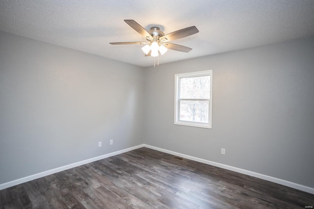 empty room with dark wood-type flooring, ceiling fan, and a textured ceiling