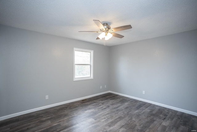 empty room with ceiling fan, a textured ceiling, and dark hardwood / wood-style flooring