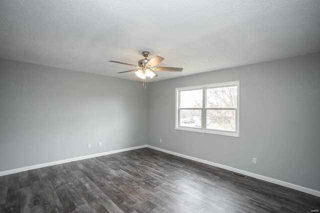 empty room featuring a textured ceiling, dark hardwood / wood-style floors, and ceiling fan