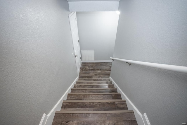 stairway featuring wood-type flooring