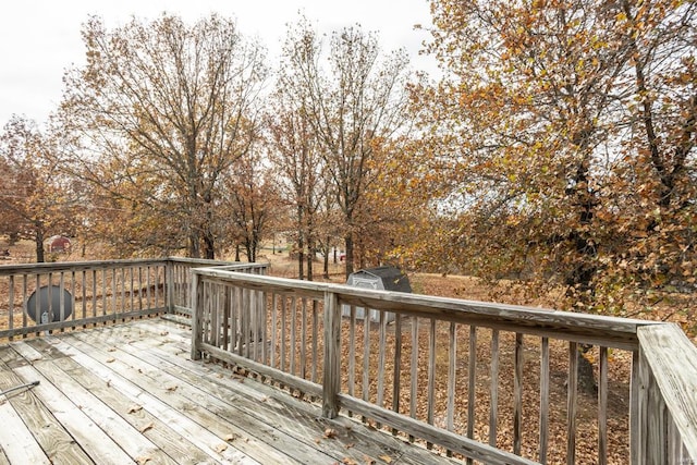 wooden deck featuring a storage unit