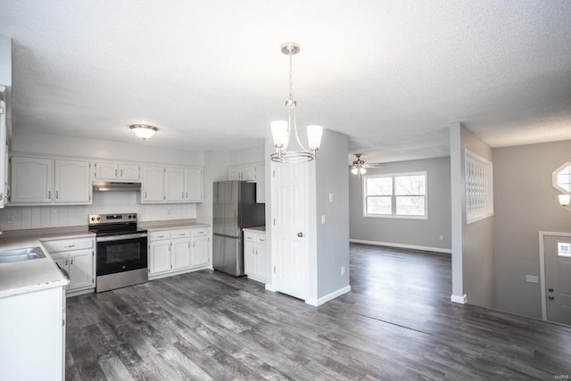 kitchen with decorative backsplash, dark hardwood / wood-style floors, stainless steel appliances, pendant lighting, and white cabinetry