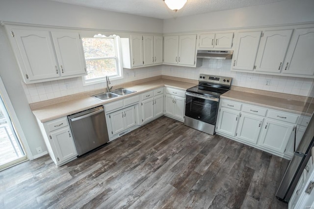 kitchen with white cabinets, tasteful backsplash, dark hardwood / wood-style floors, sink, and stainless steel appliances