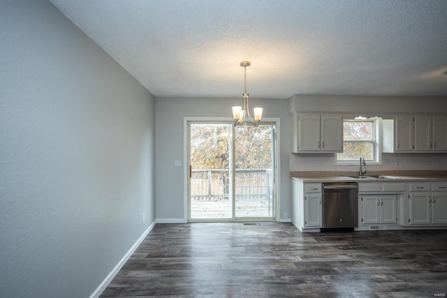 kitchen with dark hardwood / wood-style flooring, backsplash, dishwasher, decorative light fixtures, and sink