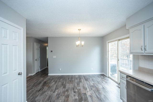 kitchen featuring dishwasher, hanging light fixtures, white cabinets, dark wood-type flooring, and a chandelier