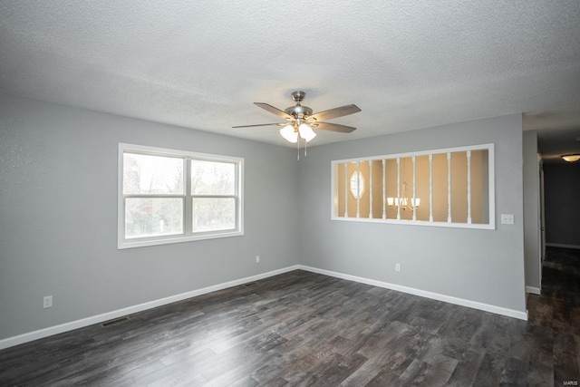 unfurnished room with ceiling fan, a textured ceiling, and dark hardwood / wood-style floors