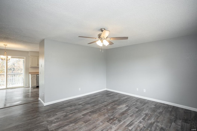 empty room featuring a textured ceiling, ceiling fan with notable chandelier, and dark hardwood / wood-style flooring