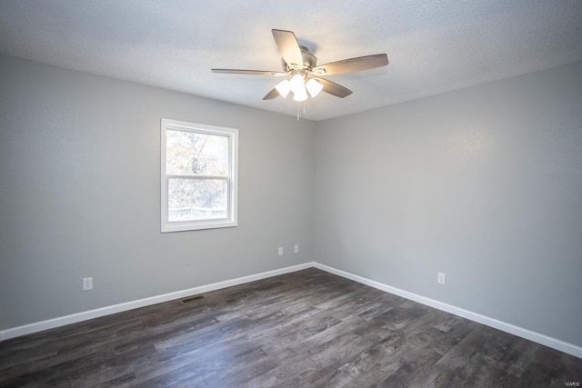 empty room with dark wood-type flooring, a textured ceiling, and ceiling fan